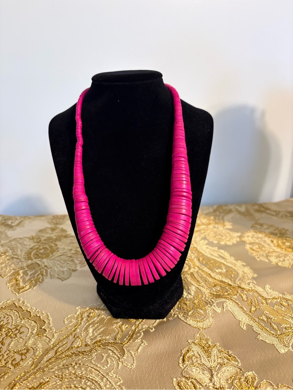A vintage pink wooden disc bead statement necklace.